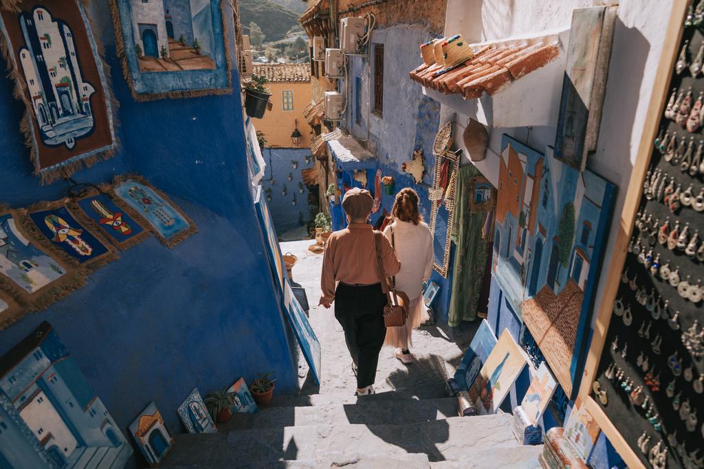 Rear View 2 Asian Chinese Female Tourist Shopping In Souk Market In Chefchaouen